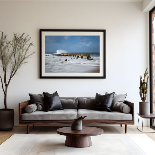 Modern living room with a sofa, coffee table, and framed artwork on the wall.